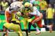 EUGENE, OR - SEPTEMBER 14: Byron Marshall #9 of the Oregon Ducks runs the ball as A.J. Johnson #45 and Trevarris Saulsberry #96 of the Tennessee Volunteers move in for the tackle on September 14, 2013 at the Autzen Stadium in Eugene, Oregon. (Photo by J