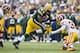 GREEN BAY, WI - SEPTEMBER 15: James Starks #44 of the Green Bay Packers rushes the ball and is hit by Reed Doughty #37 of the Washington Redskins at Lambeau Field on September 15, 2013 in Green Bay, Wisconsin. The Packers defeated the Redskins 38-20. (Pho