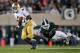 EAST LANSING, MI - SEPTEMBER 15: Theo Riddick #6 of the Notre Dame Fighting Irish can't outrun the diving tackle of William Gholston #2 of the Michigan State Spartans during a fourth quarter run at Spartan Stadium Stadium on September 15, 2012 in East La