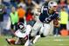 FOXBORO, MA - AUGUST 29: Tim Tebow #5 of the New England Patriots evades a tackle and runs with the ball past Adewale Ojomo #71 of the New York Giants during the preseason game at Gillette Stadium on August 29, 2013 in Foxboro, Massachusetts. (Photo by Ja