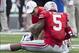 Aug 31, 2013; Columbus, OH, USA; Ohio State Buckeyes quarterback Braxton Miller (5) is treated by a member of the training staff after a play against the Buffalo Bulls at Ohio Stadium. Ohio State won the game 40-20. Mandatory Credit: Greg Bartram-USA TODA