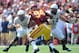 LOS ANGELES, CA - SEPTEMBER 21: Chuckie Keeton #16 of the Utah State Aggies scrambles in front of Leonard Williams #94 of the USC Trojans and Jamie Markosian #54 during a 17-14 loss to the Trojans at the Los Angeles Memorial Coliseum on September 21, 201
