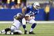 INDIANAPOLIS, IN - SEPTEMBER 08: Andrew Luck #12 of the Indianapolis Colts runs with the ball while defended by Jason Hunter #93 of the Oakland Raiders during the Colts 21-17 win at Lucas Oil Stadium on September 8, 2013 in Indianapolis, Indiana. (Photo