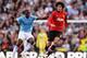 MANCHESTER, ENGLAND - SEPTEMBER 22: Marouane Fellaini of Manchester United evades Yaya Toure of Manchester City during the Barclays Premier League match between Manchester City and Manchester United at the Etihad Stadium on September 22, 2013 in Manchest