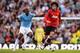 MANCHESTER, ENGLAND - SEPTEMBER 22: Marouane Fellaini of Manchester United evades Yaya Toure of Manchester City during the Barclays Premier League match between Manchester City and Manchester United at the Etihad Stadium on September 22, 2013 in Manchest