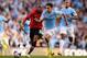 MANCHESTER, ENGLAND - SEPTEMBER 22: Jesus Navas of Manchester City is chased by Ashley Young of Manchester United during the Barclays Premier League match between Manchester City and Manchester United at the Etihad Stadium on September 22, 2013 in Manche