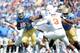 PASADENA, CA - SEPTEMBER 17: Johnathan Franklin #23 of the UCLA Bruins runs against Jordan Hicks #3 of the Texas Longhorns during the game at Rose Bowl on September 17, 2011 in Pasadena, California. (Photo by Harry How/Getty Images)