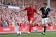 LIVERPOOL, ENGLAND - SEPTEMBER 21: Lucas of Liverpool in action with Adam Lallana of Southampton during the Barclays Premier League match between Liverpool and Southampton at Anfield on September 21, 2013 in Liverpool, England. (Photo by Clive Brunskill/
