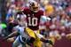 LANDOVER, MD - SEPTEMBER 22: Robert Griffin III #10 of the Washington Redskins scrambles with the ball as he avoids the tackle of Ezekiel Ansah #94 of the Detroit Lions in the first half during a game at FedExField on September 22, 2013 in Landover, Mary