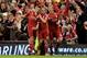 LIVERPOOL, ENGLAND - JANUARY 25: Steven Gerrard of Liverpool celebrates scoring his team's first goal from a penalty with Craig Bellamy and Dirk Kuyt (R) during the Carling Cup Semi Final Second Leg match between Liverpool and Manchester City at Anfield