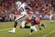 DENVER, CO - SEPTEMBER 12: Darren McFadden #20 of the Oakland Raiders is tackled by Champ Bailey #24 of the Denver Broncos at the one yard line after rushing for 47 yards to set up a fourth quarter touchdown at Sports Authority Field at Mile High on Sep