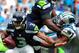 CHARLOTTE, NC - SEPTEMBER 08: Greg Hardy #76 of the Carolina Panthers fights to get around Russell Okung #76 and sack quarterback Russell Wilson #2 of the Seattle Seahawks during play at Bank of America Stadium on September 8, 2013 in Charlotte, North Ca