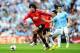 MANCHESTER, ENGLAND - SEPTEMBER 22: Marouane Fellaini of Manchester United holds off Jesus Navas of Manchester City during the Barclays Premier League match between Manchester City and Manchester United at the Etihad Stadium on September 22, 2013 in Manc
