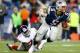 FOXBORO, MA - AUGUST 29: Tim Tebow #5 of the New England Patriots evades a tackle and runs with the ball past Adewale Ojomo #71 of the New York Giants during the preseason game at Gillette Stadium on August 29, 2013 in Foxboro, Massachusetts. (Photo by Ja