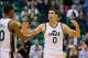 October 25, 2012; Salt Lake City, UT, USA; Utah Jazz center Enes Kanter (0) and Utah Jazz point guard Alec Burks (10) celebrate their pending victory with just seconds remaining in the second half against the Portland Trail Blazers at EnergySolutions Aren