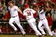 CINCINNATI, OH - SEPTEMBER 23: Devin Mesoraco #39 is congratulated by Jay Bruce #32 and Brandon Phillips #4 of the Cincinnati Reds after scoring the winning run during the 10th inning against the New York Mets at Great American Ball Park on September 23,