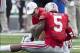 Aug 31, 2013; Columbus, OH, USA; Ohio State Buckeyes quarterback Braxton Miller (5) is treated by a member of the training staff after a play against the Buffalo Bulls at Ohio Stadium. Ohio State won the game 40-20. Mandatory Credit: Greg Bartram-USA TODA