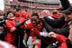 COLUMBUS, OH - NOVEMBER 24: Kenny Guiton #13 of the Ohio State Buckeyes is mobbed by fans on the field after Ohio State defeated the Michigan Wolverines 26-21at Ohio Stadium on November 24, 2012 in Columbus, Ohio. (Photo by Jamie Sabau/Getty Images)