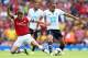 LONDON, ENGLAND - SEPTEMBER 01: Aaron Ramsey of Arsenal tackles Andros Townsend of Spurs during the Barclays Premier League match between Arsenal and Tottenham Hotspur at Emirates Stadium on September 01, 2013 in London, England. (Photo by Clive Mason/