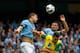 MANCHESTER, ENGLAND - MAY 19: Edin Dzeko (L) and Aleksander Kolarov of Manchester City in action with Russell Martin (R) of Norwich during the Barclays Premier League match between Manchester City and Norwich City at the Etihad Stadium on May 19, 2013 in