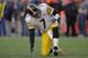 DENVER, CO - JANUARY 08: Quarterback Ben Roethlisberger #7 of the Pittsburgh Steelers gets up slowly after throwing an interception to Quinton Carter #28 of the Denver Broncos in the second quarter at Sports Authority Field at Mile High on January 8, 201