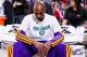 PORTLAND, OR - APRIL 10: Kobe Bryant #24 of the Los Angeles Lakers, wearing an NBA Green Week T-shirt, sits on the bench before playing against the Portland Trail Blazers on April 10, 2013 at the Rose Garden Arena in Portland, Oregon. NOTE TO USER: User e