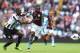 BIRMINGHAM, ENGLAND - SEPTEMBER 14: Christian Benteke of Aston Villa tangles with Mapou Yanga-Mbiwa of Newcastle United during the Barclays Premier League match between Aston Villa and Newcastle United at Villa Park on September 14, 2013 in Birmingham, E