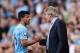 MANCHESTER, ENGLAND - SEPTEMBER 22: Manuel Pellegrini manager of Manchester City talks to Sergio Aguero of Manchester City as he is substituted during the Barclays Premier League match between Manchester City and Manchester United at the Etihad Stadium o