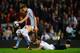 BIRMINGHAM, ENGLAND - SEPTEMBER 24: Jan Vertonghen of Tottenham Hotspur hangs on to the shorts of Nicklas Helenius of Aston Villa during the Capital One Cup third round match between Aston Villa and Tottenham Hotspur at Villa Park on September 24, 2013 in
