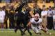 TEMPE, AZ - SEPTEMBER 14: Quarterback Taylor Kelly #10 of the Arizona State Sun Devils looks to pass under pressure from linebacker Chris Borland #44 of the Wisconsin Badgers during the college football game at Sun Devil Stadium on September 14, 2013 in