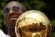 LOS ANGELES, CA - JUNE 21: The crowd is reflected in the championship trophy held by Los Angeles Lakers guard Kobe Bryant as he rides in the victory parade for the the NBA basketball champion team on June 21, 2010 in Los Angeles, California. The Lakers b