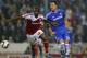 SWINDON, ENGLAND - SEPTEMBER 24: Dany N'Guessan (L) of Swindon Townholds off a challenge from John Terry (R) of Chelsea during the Capital One Cup third round match between Swindon Town and Chelsea at the County Ground on September 24, 2013 in Swindon, En