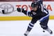 WINNIPEG, MB - SEPTEMBER 26: Olli Jokinen #12 of the Winnipeg Jets misses the puck as he attempts to score against the Boston Bruins in second period action during an NHL preseason game at the MTS Centre on September 26, 2013 in Winnipeg, Manitoba, Canada