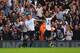 LONDON, ENGLAND - SEPTEMBER 28: Gylfi Sigurdsson of Tottenham Hotspur (22) celebrates in front of fans with Roberto Soldado (L) and Christian Eriksen (R) during the Barclays Premier League match between Tottenham Hotspur and Chelsea at White Hart Lane on