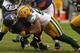 CHICAGO, IL - DECEMBER 16: Clay Matthews #52 of the Green Bay Packers drops Armando Allen #25 of the Chicago Bears at Soldier Field on December 16, 2012 in Chicago, Illinois. The Packers defeated the Bears 21-13. (Photo by Jonathan Daniel/Getty Images)