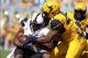 Sep 28, 2013; Morgantown, WV, USA; Oklahoma State Cowboys wide receiver Tracy Moore (87) is tackled by West Virginia Mountaineers linebacker Doug Rigg (47) during the first half at Milan Puskar Stadium. Mandatory Credit: Peter Casey-USA TODAY Sports