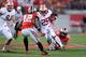 COLUMBUS, OH - SEPTEMBER 28: Melvin Gordon #25 of the Wisconsin Badgers picks up yardage in the first quarter as Doran Grant #12 of the Ohio State Buckeyes and Ryan Shazier #10 of the Ohio State Buckeyes defend at Ohio Stadium on September 28, 2013 in Co