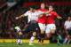 MANCHESTER, ENGLAND - SEPTEMBER 25: Luis Suarez of Liverpool shoots under pressure from Rafael of Manchester United during the Capital One Cup Third Round match betwen Manchester United and Liverpool at Old Trafford on September 25, 2013 in Manchester, E