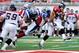 MONTREAL, CANADA - JULY 12: Jon Cornish #9 of the Calgary Stampeders rushes with the ball while being held by John Bowman #7 of the Montreal Alouettes during the CFL game at Percival Molson Stadium on July 13, 2013 in Montreal, Quebec, Canada. The Stamp