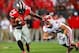 Sep 28, 2013; Columbus, OH, USA; Ohio State Buckeyes running back Carlos Hyde (34) stiff arms Wisconsin Badgers linebacker Chris Borland (44) during the first quarter at Ohio Stadium. Mandatory Credit: Andrew Weber-USA TODAY Sports