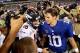 Sep 15, 2013; East Rutherford, NJ, USA; Denver Broncos quarterback Peyton Manning (18) shakes hands with New York Giants quarterback Eli Manning (10) after a game at MetLife Stadium. The Broncos defeated the Giants 41-23. Mandatory Credit: Brad Penner-USA