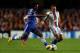 LONDON, ENGLAND - SEPTEMBER 18: Willian of Chelsea and Kay Voser of FC Basel battle for the ball during the UEFA Champions League Group E Match between Chelsea and FC Basel at Stamford Bridge on September 18, 2013 in London, England. (Photo by Clive Ros