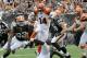 Sep 29, 2013; Cleveland, OH, USA; Cincinnati Bengals quarterback Andy Dalton (14) tries to elude Cleveland Browns defense during the third quarter at FirstEnergy Stadium. The Browns beat the Bengals 17-6. Mandatory Credit: Ken Blaze-USA TODAY Sports