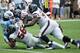 HOUSTON, TX - SEPTEMBER 15: Chris Johnson #28 of the Tennessee Titans is tackled by a group of Houston Texans at Reliant Stadium on September 15, 2013 in Houston, Texas. (Photo by Scott Halleran/Getty Images)