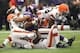 MINNEAPOLIS, MN - SEPTEMBER 22: Adrian Peterson #28 of the Minnesota Vikings gets tackled by Buster Skrine #22, Barkevious Mingo #51 and T.J. Ward #43 of the Cleveland Browns on September 22, 2013 at Mall of America Field at the Hubert Humphrey Metrodome