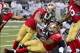 Sep 26, 2013; St. Louis, MO, USA; San Francisco 49ers defensive end Justin Smith (94) and 49ers linebacker Corey Lemonier (96) tackle St. Louis Rams running back Daryl Richardson (26) during the first half at the Edward Jones Dome. Mandatory Credit: Scott