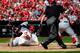 Rookie Matt Adams slides into home plate against the Nationals on Sept. 25.