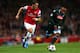 LONDON, ENGLAND - OCTOBER 01: Mesut Oezil of Arsenal goes past Camilo Zuniga of Napoli during UEFA Champions League Group F match between Arsenal FC and SSC Napoli at Emirates Stadium on October 1, 2013 in London, England. (Photo by Paul Gilham/Getty Im