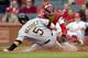 ST. LOUIS - APRIL 9: Ramon Vazquez #5 of the Pittsburgh Pirates slides safely into home against Yadier Molina #5 of the St. Louis Cardinals on April 9, 2009 at Busch Stadium in St. Louis, Missouri. The Cardinals beat the Pirates 2-1. (Dilip Vishwanat/Ge