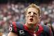HOUSTON, TX- SEPTEMBER 29: J.J. Watt #99 of the Houston Texans leaves the field after losing to the Seattle Seahawks on September 29, 2013 at Reliant Stadium in Houston, Texas. (Photo by Thomas B. Shea/Getty Images)